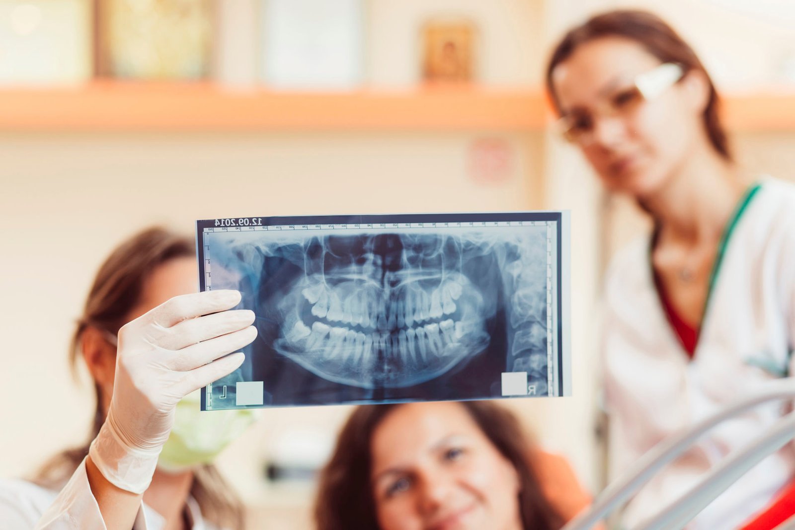 Dentist reviewing a panoramic dental X-ray with a patient
