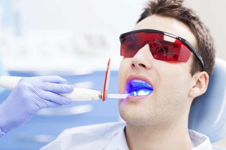 Patient receiving an in-office laser teeth-whitening treatment